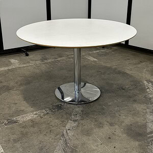 Herman Miller Everywhere table with a white top and chrome base, ideal for versatile office or confe.