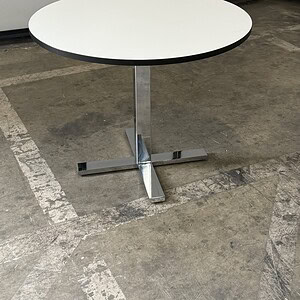White round table with chrome pedestal base, 32-inch diameter, perfect for modern office or dining s.