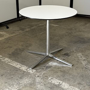 White round occasional table with chrome base, ideal for modern office or lounge spaces.