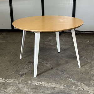 Round maple table with a white base, measuring 46 inches in width, perfect for dining or workspace.