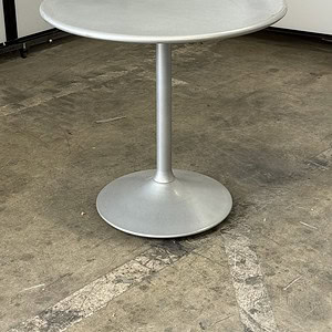 Outdoor round metal table for patio and garden use.