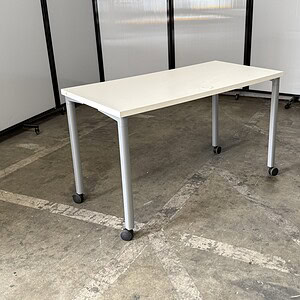 Herman Miller white top table with silver legs, 4'x2' size, on casters for mobility. Ideal for offic.