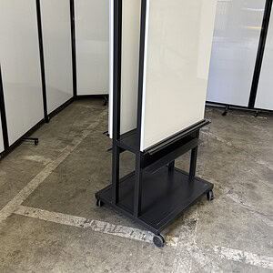 Whiteboard with removable boards, black metal base, and casters for versatile use.