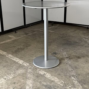 Silver metal outdoor bar table, 31-inch wide and 42-inch tall, perfect for outdoor seating areas.