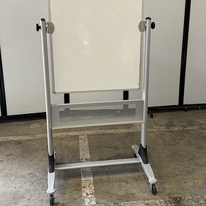 Portable whiteboard on stand with wheels for easy mobility.