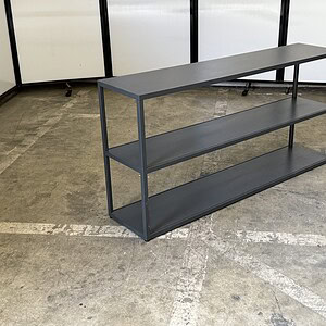 Modern graphite metal credenza with three shelves, 60" wide, ideal for office storage.