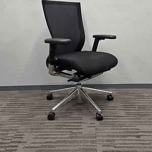 Black ergonomic office chair with mesh back, chrome base, and adjustable armrests for comfort.