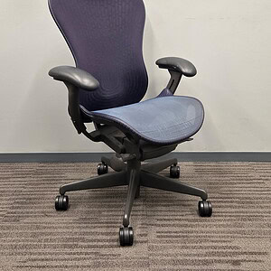 Herman Miller Mirra ergonomic office chair in blue and gray for workspace comfort.