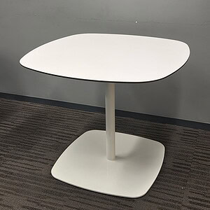 White round table with a sleek design and sturdy base for modern office spaces.