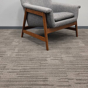 West Elm neutral grey and espresso lounge chair with wooden legs.