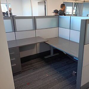 Modern Ethospace frosted glass cubicles with desk and privacy panels.