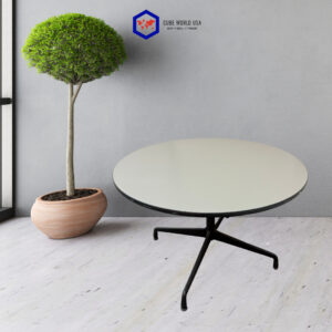 Round gray table with black metal legs and a potted green tree.