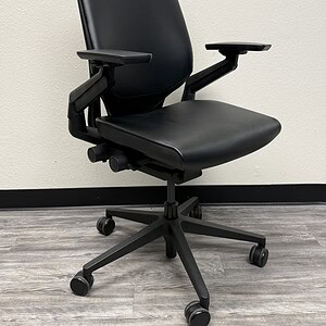 Ergonomic black leather office chair with adjustable armrests and lumbar support. Perfect for profes.