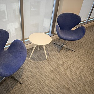 OFS Swivel Lounge Chairs Navy with Chrome Base in modern office setting.