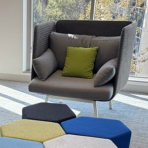 Back grey acoustical club chair for open office environments.