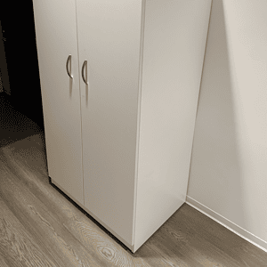 White 2-door vertical storage cabinet for organization and space-saving.