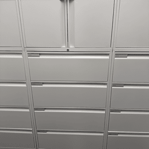Lateral storage cabinet with four drawers, ideal for office organization.