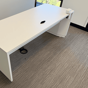 Adjustable white height desk with ergonomic design, perfect for modern office setups.
