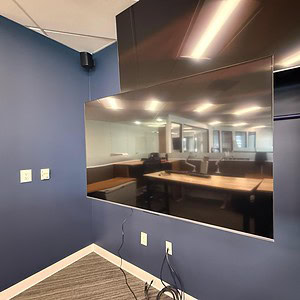Large 56-inch LG TV wall display in a professional office environment.