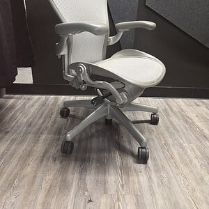 Aeron B Silver ergonomic office chair by Herman Miller, perfect for workspace comfort and support.