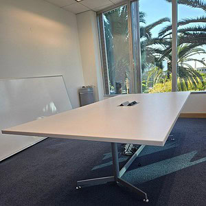 Kimball 8x4 conference table in modern office setting with large windows and scenic outdoor view.