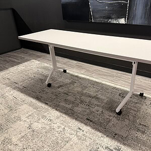 Nesting table with white base, ideal for office or conference room settings. Space-saving design for.