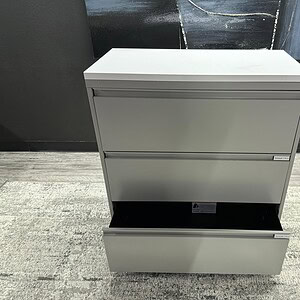 Durable 3-drawer lateral file with sleek white top for office organization.