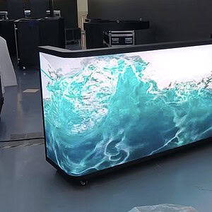 LED reception desk with custom water-themed logo, 6’ or 7’ wide on casters for versatile use.