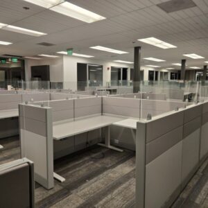 Office cubicles with glass walls and beige accents for a professional workspace.