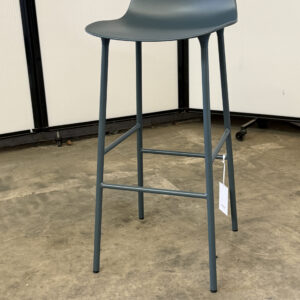 Grey bar height stool with curved seat and four legs.