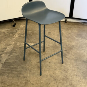 Grey counter height stool with curved seat, ideal for kitchen or bar seating.