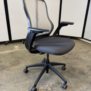 Knoll Regeneration office chair with black frame, white mesh back, and black seat.
