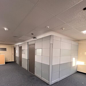 Contemporary private office with white and gray panels in Cube World USA.