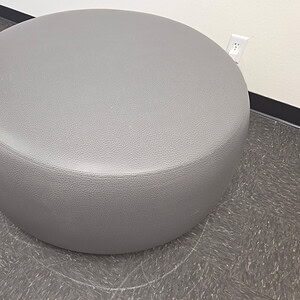 Grey leather ottoman, 40-inch wide, modern design for living room decor.