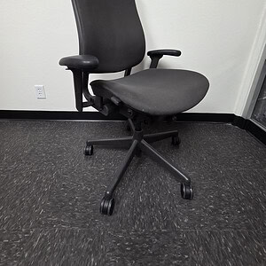 Ergonomic Herman Miller Celle office chair in grey fabric for workspace comfort.