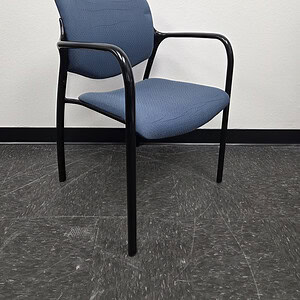 Blue Herman Miller office chair with black metal frame and armrests.