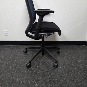 Ergonomic office chair with blue mesh back and black seat.