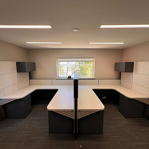 Modern Herman Miller Ethospace Hi Lo desk with overhead storage in office.