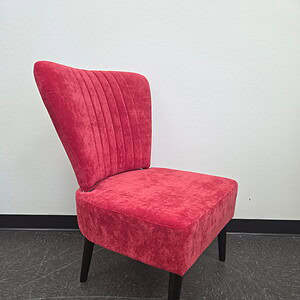 Red plush guest chair with black legs for office or reception areas.