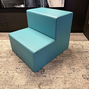 Contemporary baby blue lounge chair in stylish interior setting.