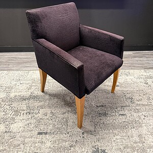 Elegant burgundy guest chair with wooden legs for office or reception.