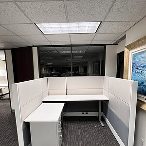 Modern Herman Miller Ethospace cubicle with white panels and desk.