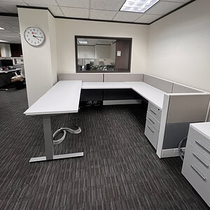 Modern office manager station with HAT table and storage drawers.