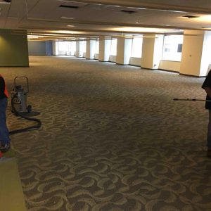 Professional carpet installation service in a large office space.