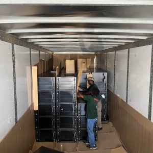 Moving storage units being assembled inside a truck.