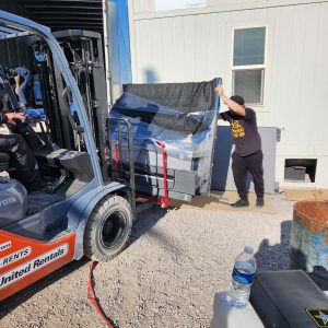 Moving office furniture during facility decommissioning at Cube World USA.