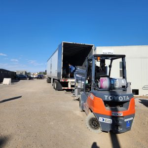Forklift unloading a truck at Cube World USA facility.