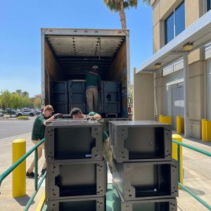 Moving equipment being unloaded at Cube World USA facility.