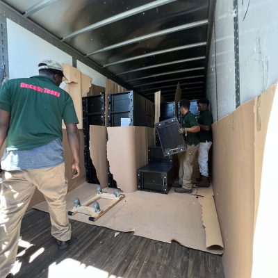 Loading professional moving equipment and furniture into a truck.