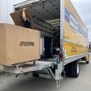 Cube World USA logistics team loading a big cube into a delivery truck.